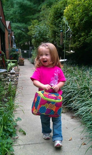 My daughter, holding her hermetically-sealed lunchbox